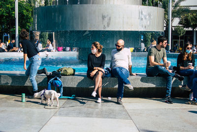 Group of people sitting in swimming pool