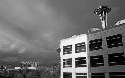 Low angle view of buildings against cloudy sky