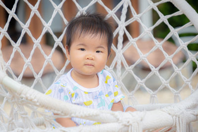 Portrait of cute baby girl in fence