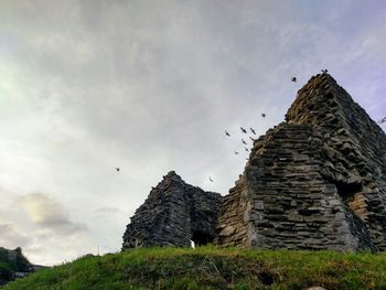 Low angle view of old building against sky