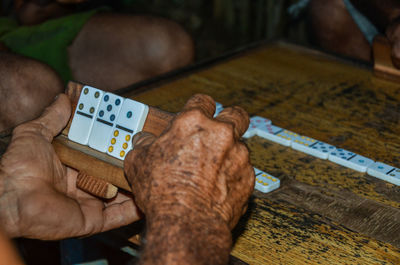 Close-up of man hand on table