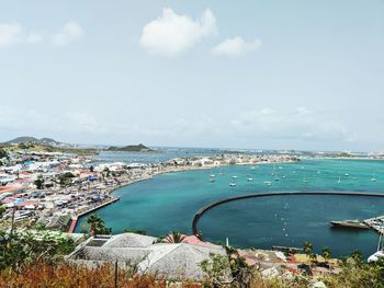 Panoramic view of sea and city against sky