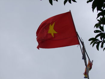 Low angle view of vietnamese flag against sky