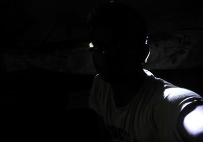 Woman standing in dark room