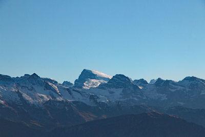 Low angle view of mountains against blue sky