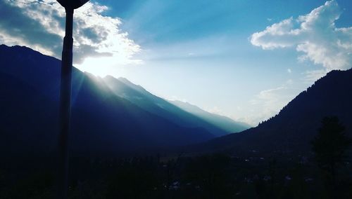 Scenic view of mountains against cloudy sky