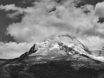 Low angle view of snowcapped mountain against sky