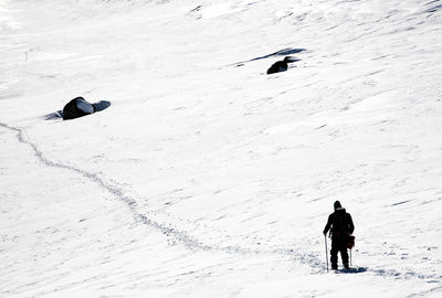 Hiker walking on snowcapped mountain