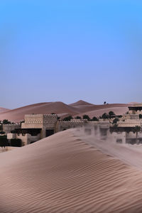 Scenic view of desert against clear blue sky