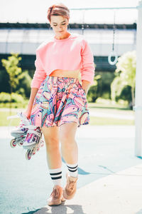 Portrait of young woman standing on street