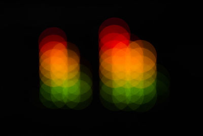 Close-up of illuminated lights against black background