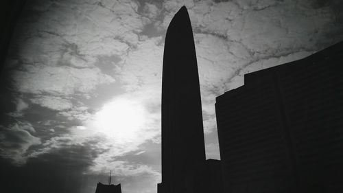 Low angle view of buildings against cloudy sky