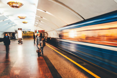 Blurred motion of train at railroad station