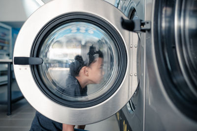 Boy looking at laundry in store 