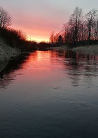 Scenic view of lake against sky at sunset