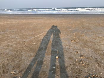 Shadow of people on beach