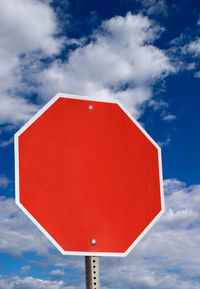 Low angle view of road sign against sky