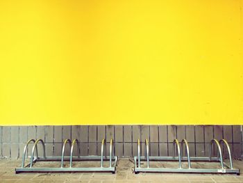 Bicycle rack against yellow wall