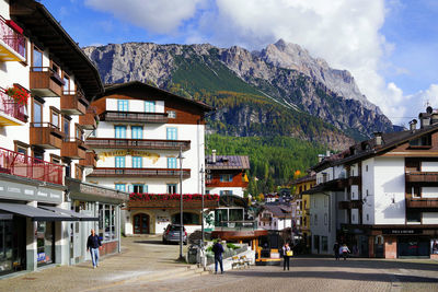 People walking on street amidst buildings in town