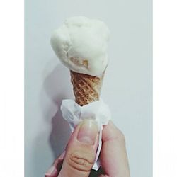 Cropped hand holding ice cream cone