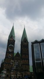 Low angle view of clock tower against sky