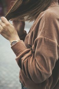 Side view of woman standing on footpath