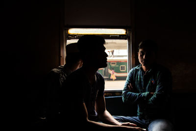 Young man sitting in the window