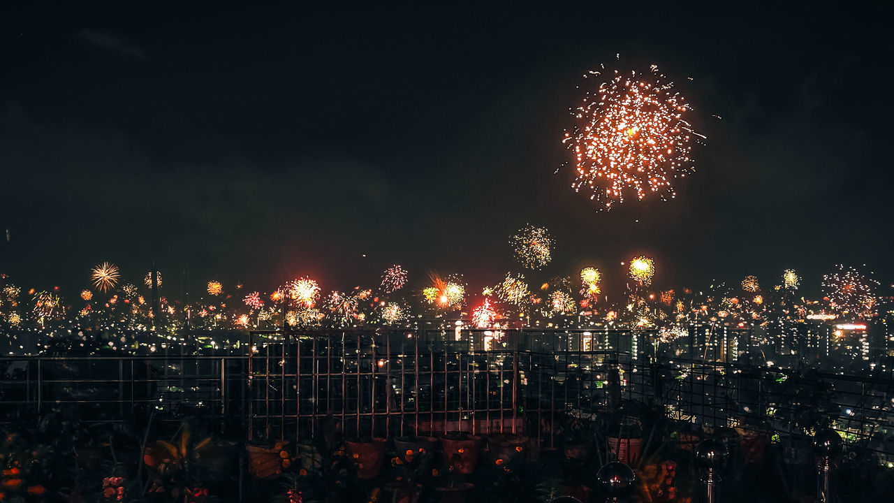 FIREWORK DISPLAY OVER ILLUMINATED CITY