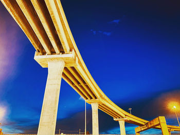 Low angle view of bridge against sky at night