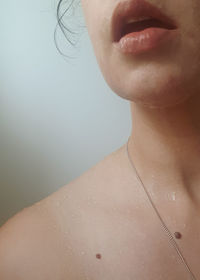 Close-up of wet woman in bathroom