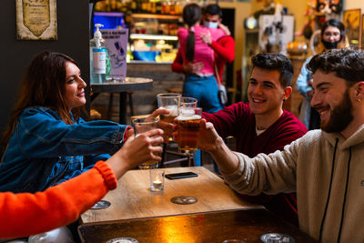 Group of people drinking beer in glass