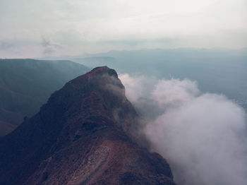 Scenic view of volcanic mountain against sky