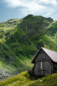 Scenic view of cabin and mountains against sky