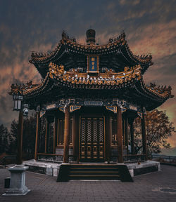 Temple building against cloudy sky