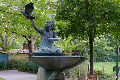 Statue against trees in park