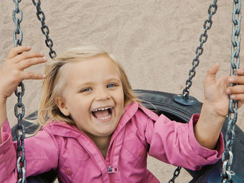 Portrait of a smiling girl on swing