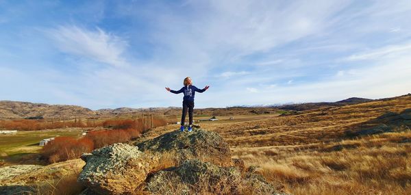 Man standing on mountain against sky