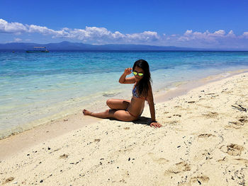 Full length of young woman on beach