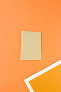 Directly above shot of paper on yellow background