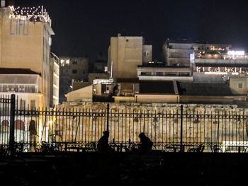 View of illuminated cityscape against sky at night