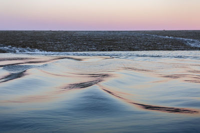 Scenic view of sea against clear sky during sunset