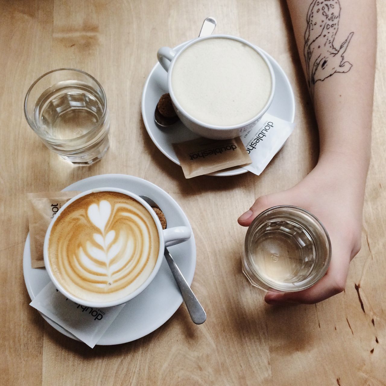 drink, food and drink, coffee cup, indoors, refreshment, coffee - drink, table, saucer, freshness, coffee, cup, still life, frothy drink, cappuccino, spoon, high angle view, tea cup, beverage, drinking glass, froth art