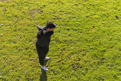 High angle view of man holding umbrella on field