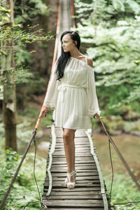 Portrait of young woman standing in boat