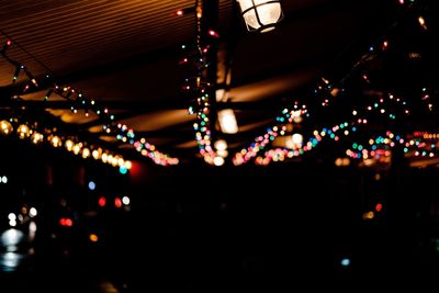Close-up of illuminated lights hanging at night