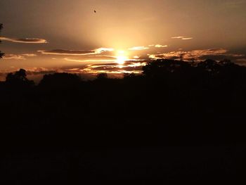 Silhouette landscape against sky during sunset