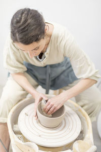 Owner working in pottery store