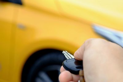 Close-up of person holding car key