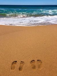 Footprints on sand at beach