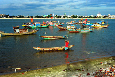 Boats moored in sea against sky